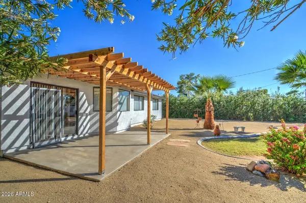 a view of a house with backyard and sitting area