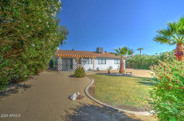 a view of a house with swimming pool and sitting area