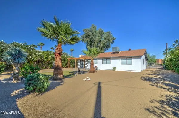 a front view of a house with a yard and a garage
