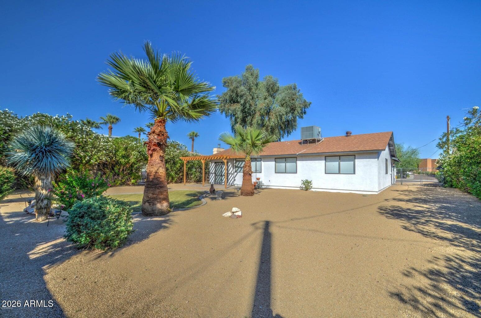 3022 North 34th Place Phoenix, AZ 85018 - Photo 38 of 40 a front view of a house with a yard and a garage