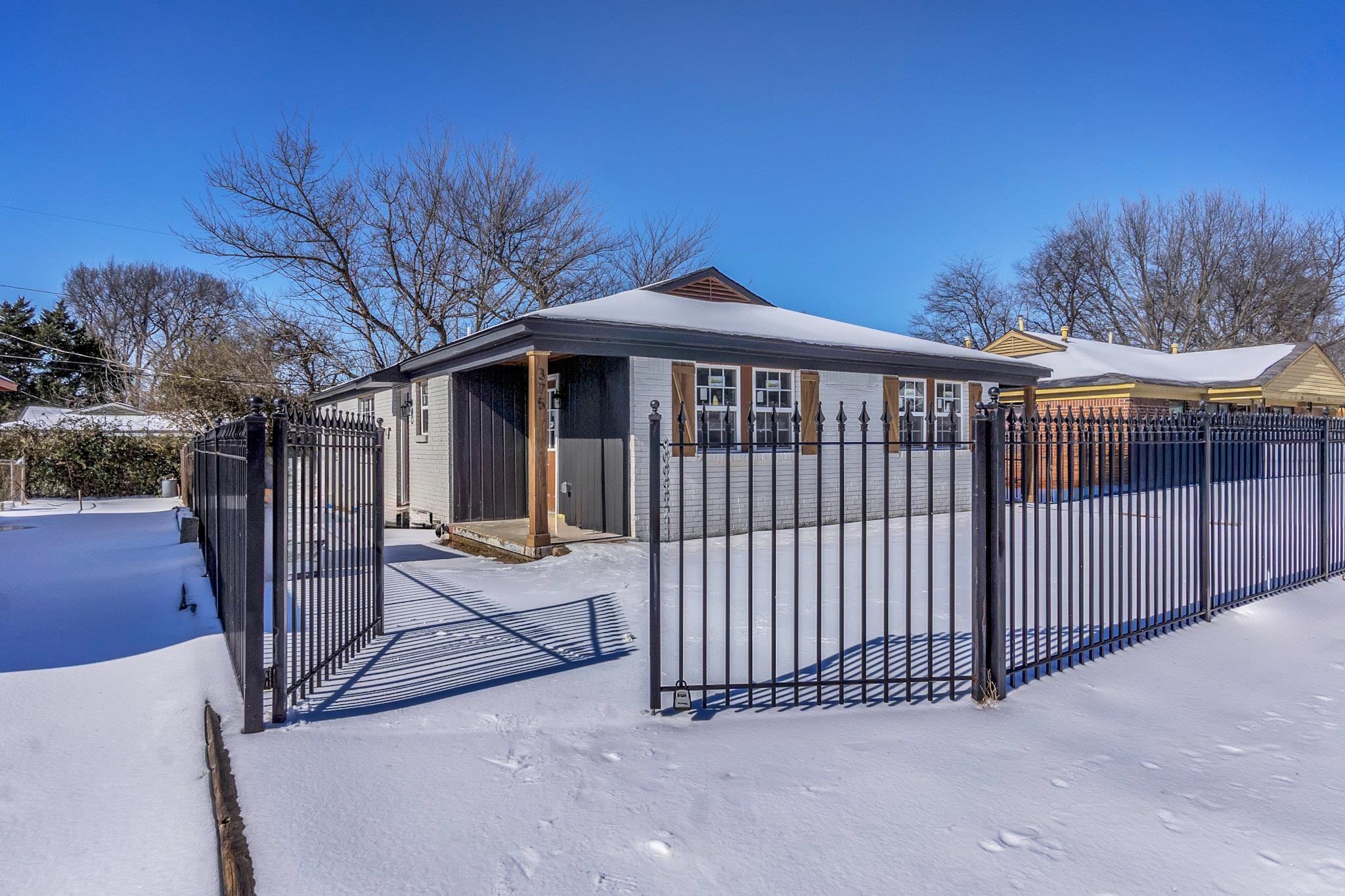 375 Pope Street Memphis, TN 38112 - Photo 2 of 19 View of side of home featuring a fenced front yard and a gate