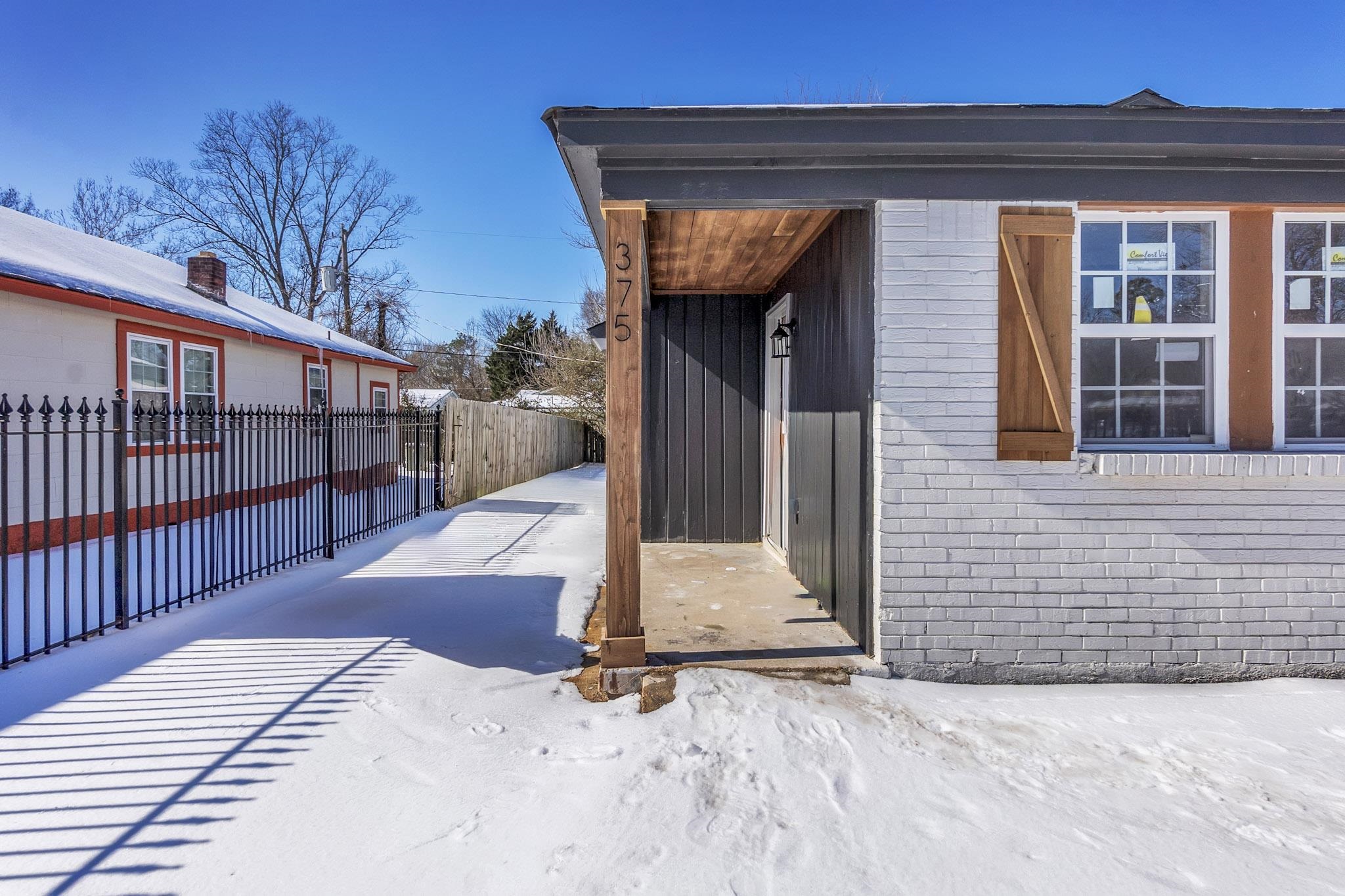 375 Pope Street Memphis, TN 38112 - Photo 3 of 19 Snow covered property entrance featuring brick siding