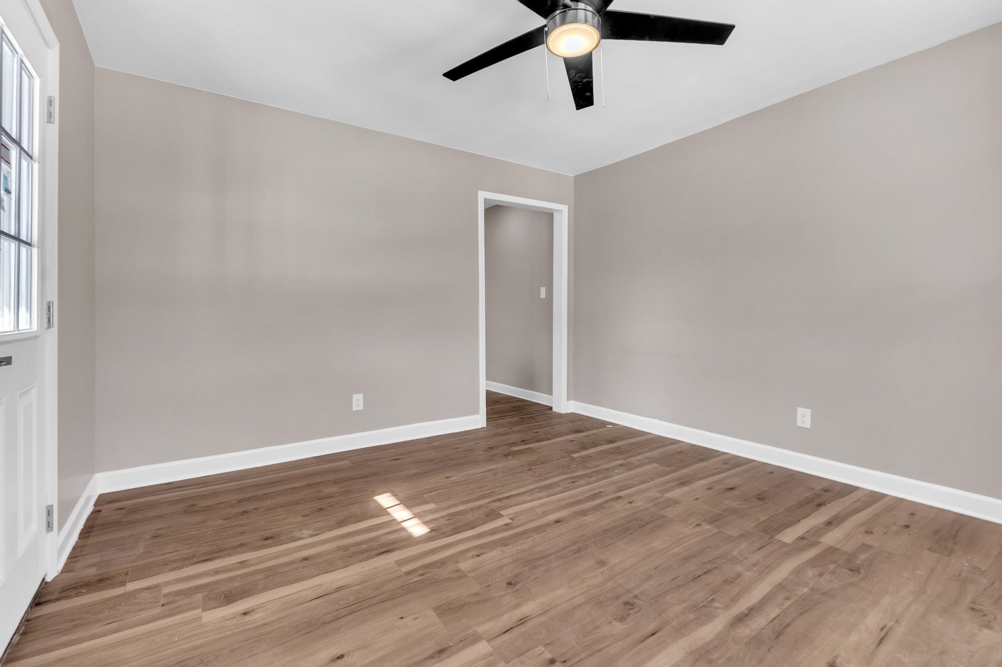 375 Pope Street Memphis, TN 38112 - Photo 5 of 19 Empty room with a ceiling fan and light wood-style floors