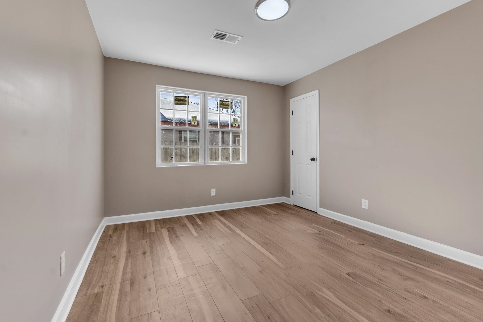375 Pope Street Memphis, TN 38112 - Photo 6 of 19 Spare room with baseboards and light wood finished floors