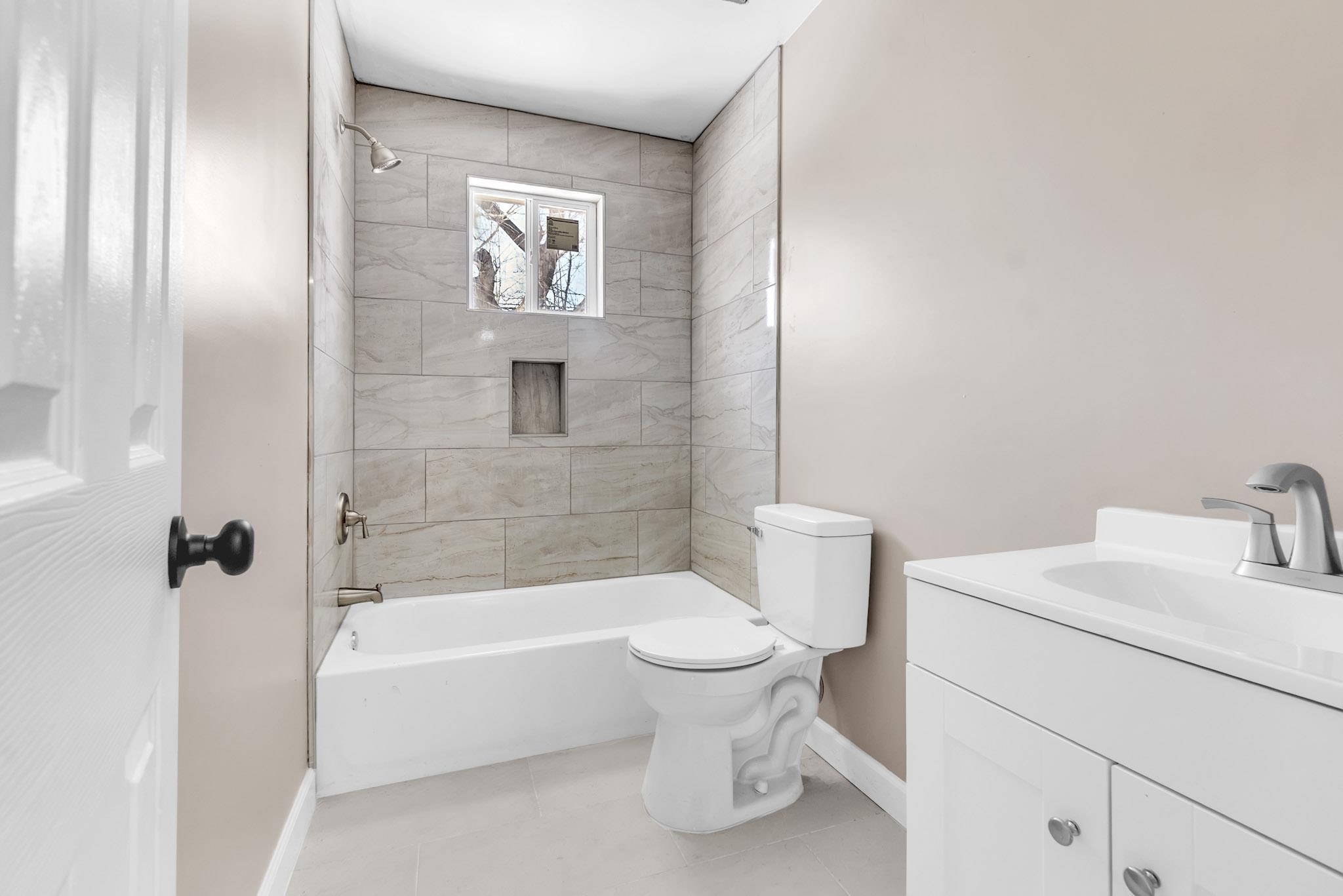 375 Pope Street Memphis, TN 38112 - Photo 9 of 19 Full bath featuring vanity, tub / shower combination, and light tile patterned floors
