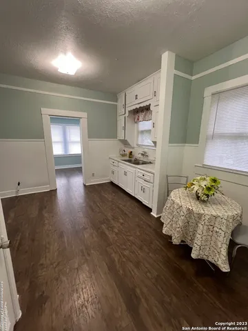 a kitchen with stainless steel appliances a bed and a stove top oven