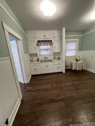 a large kitchen with a stove a refrigerator a sink dishwasher and wooden cabinets