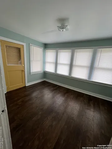 wooden floor in an empty room with a window