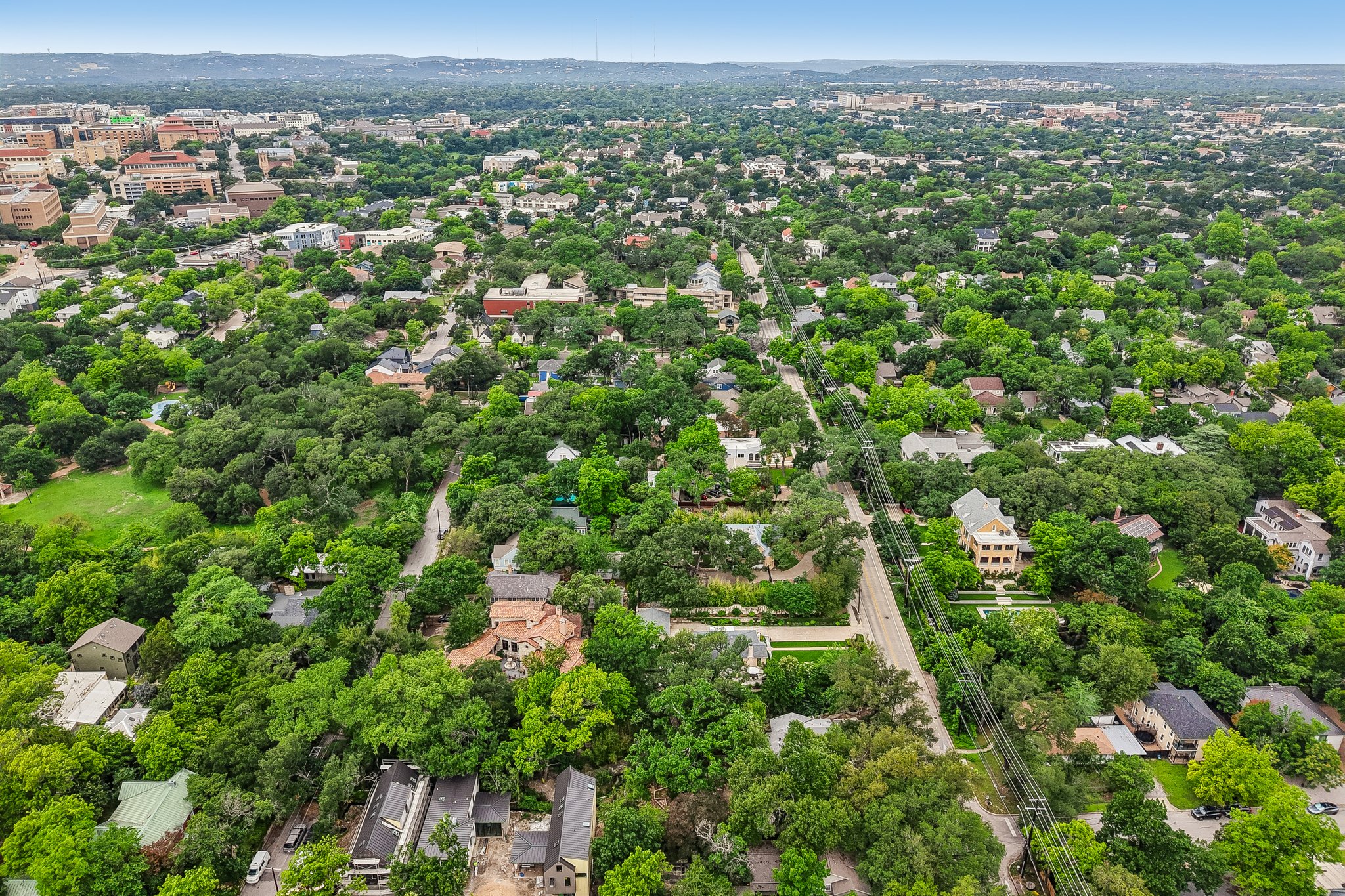 801 East 32nd Street Austin, TX 78705 - Photo 8 of 13 An aerial perspective reveals a verdant residential landscape with scattered homes and mature trees.