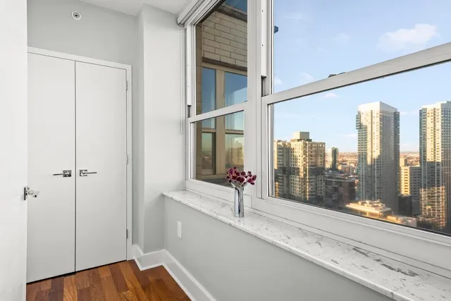 a room with stainless steel appliances kitchen island granite countertop cabinets and wooden floor