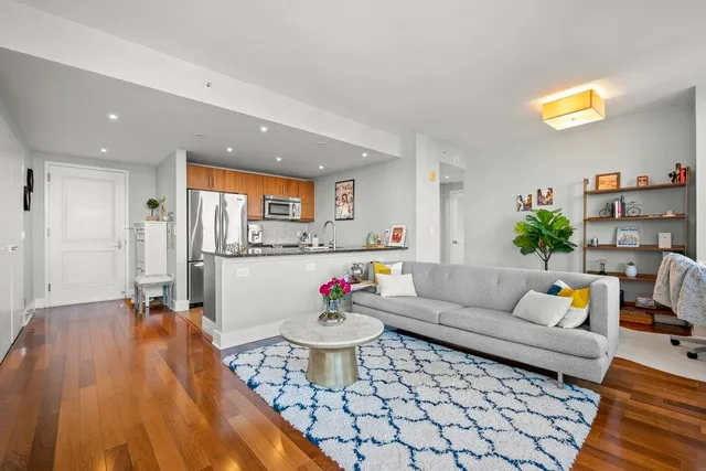 a living room filled with furniture and a large window