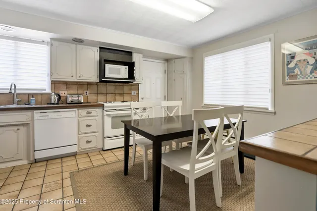a kitchen with a sink a refrigerator and a stove top oven