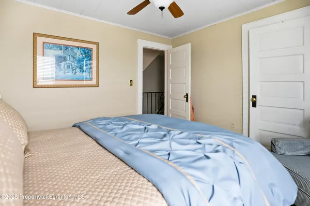 a bedroom with a large bed and a chandelier