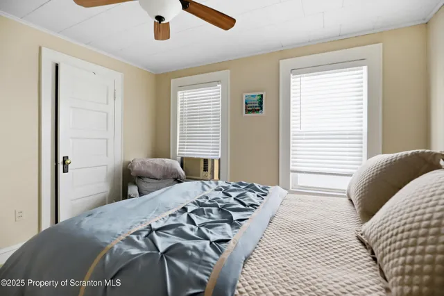 a bed sitting in a bedroom and window