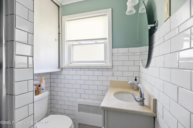 a bedroom with a bed and dresser with mirror