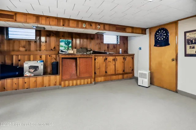 a kitchen with stainless steel appliances granite countertop a stove a refrigerator a kitchen island a dining table and chairs