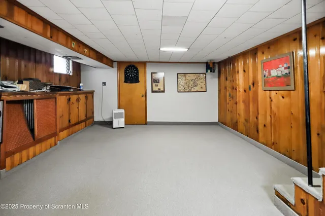 a kitchen with stainless steel appliances a table chairs and a refrigerator