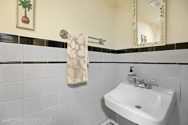 a bathroom with a sink mirror vanity and toilet