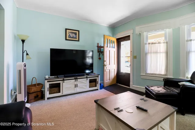 a bedroom with a bed and a lamp on dresser