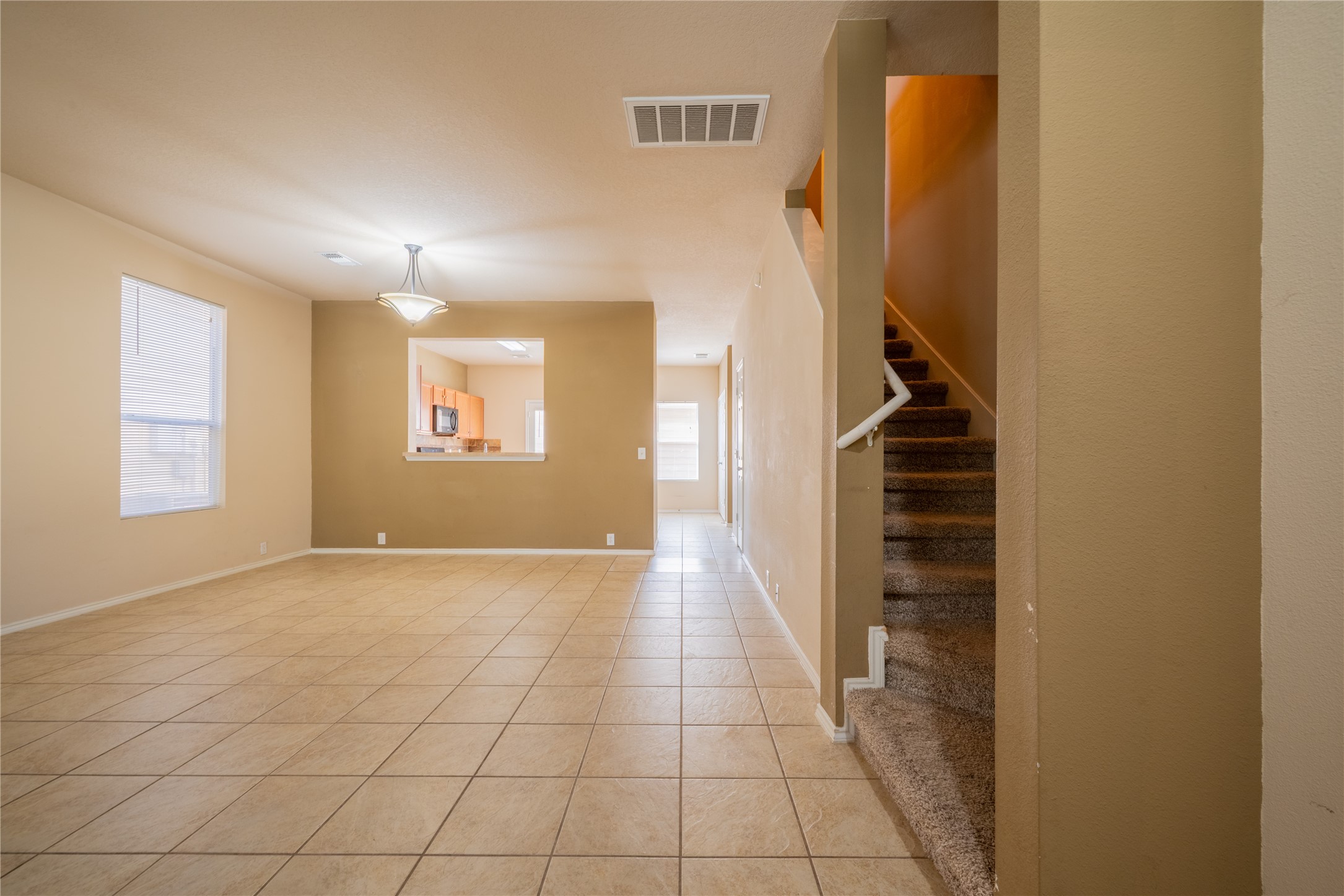 23823 Pebworth Place Spring, TX 77373 - Photo 4 of 31 a view of an empty room with stairs and a window