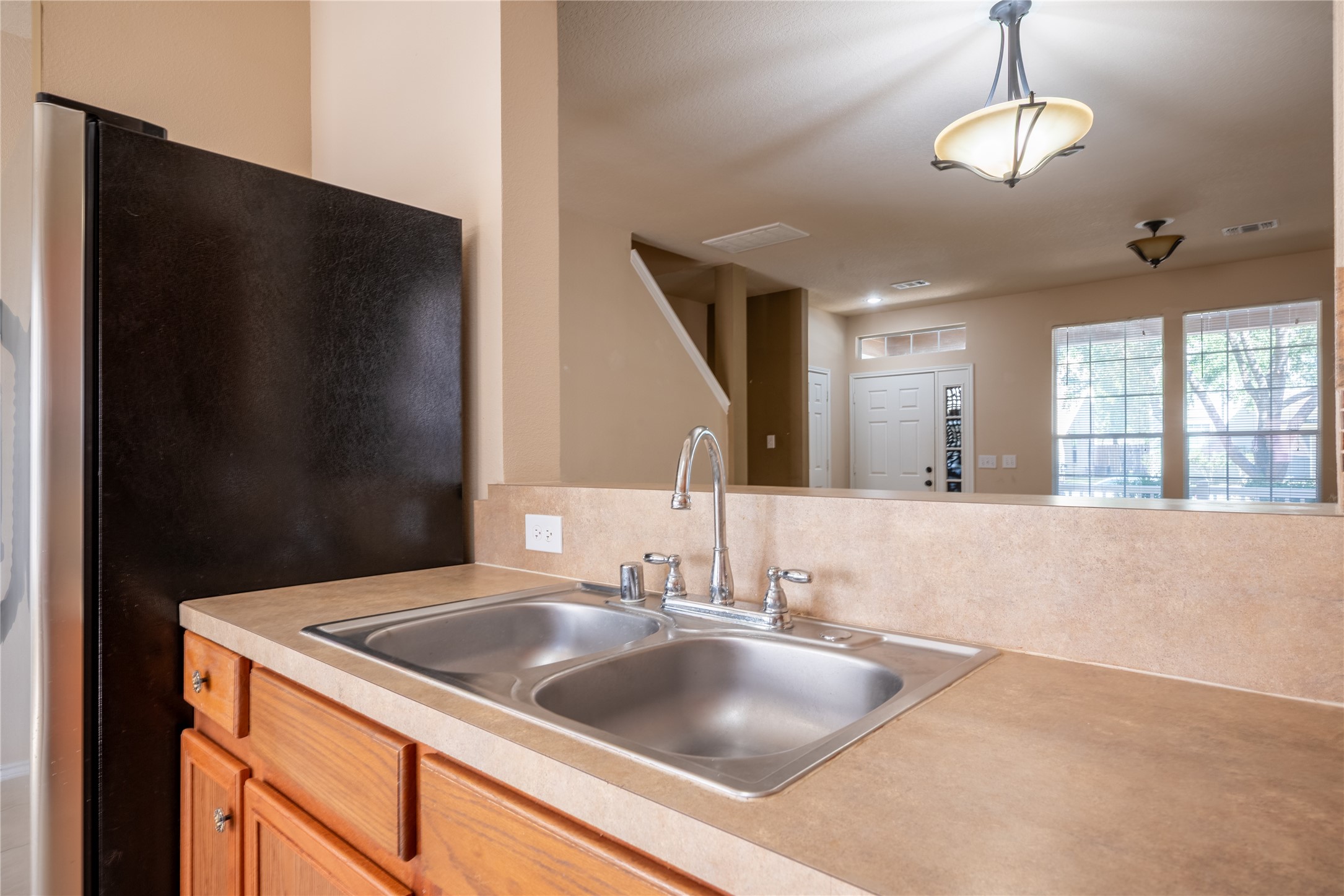 23823 Pebworth Place Spring, TX 77373 - Photo 9 of 31 a kitchen with a refrigerator and a sink