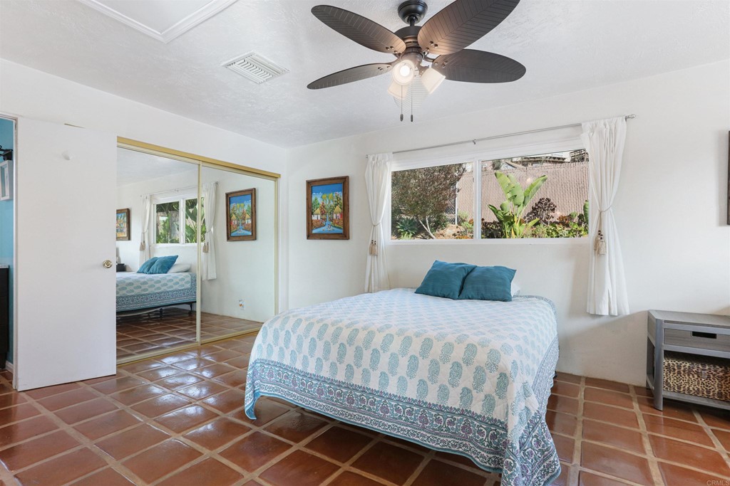 1188 Crystal Lane El Cajon, CA 92020 - Photo 12 of 26 a bedroom with a bed and a chandelier