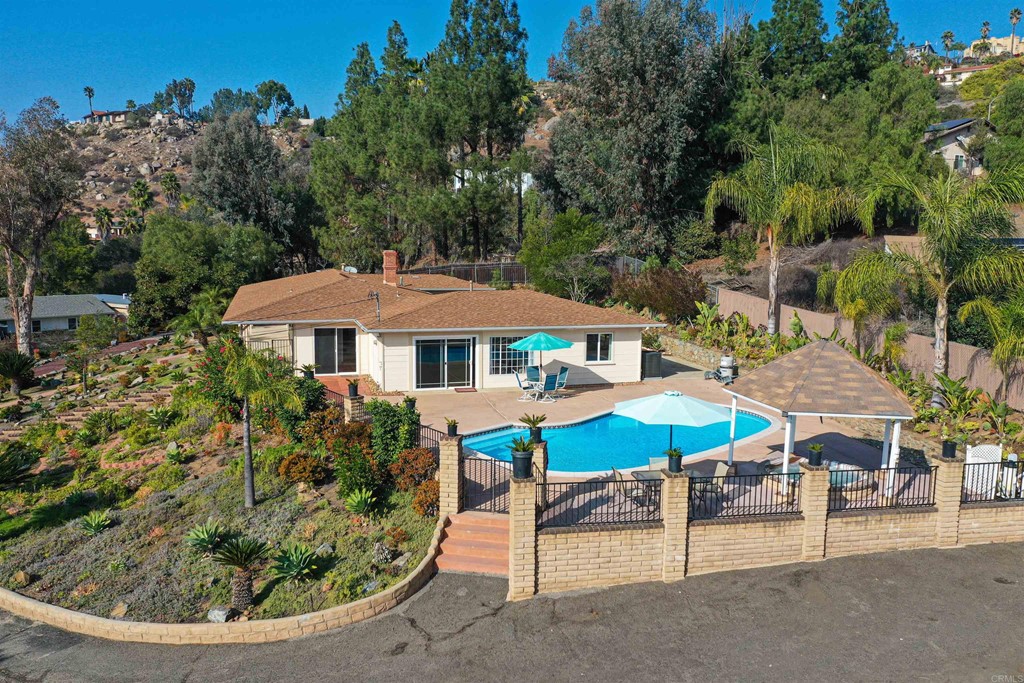 1188 Crystal Lane El Cajon, CA 92020 - Photo 4 of 26 an outdoor space with furniture and umbrella