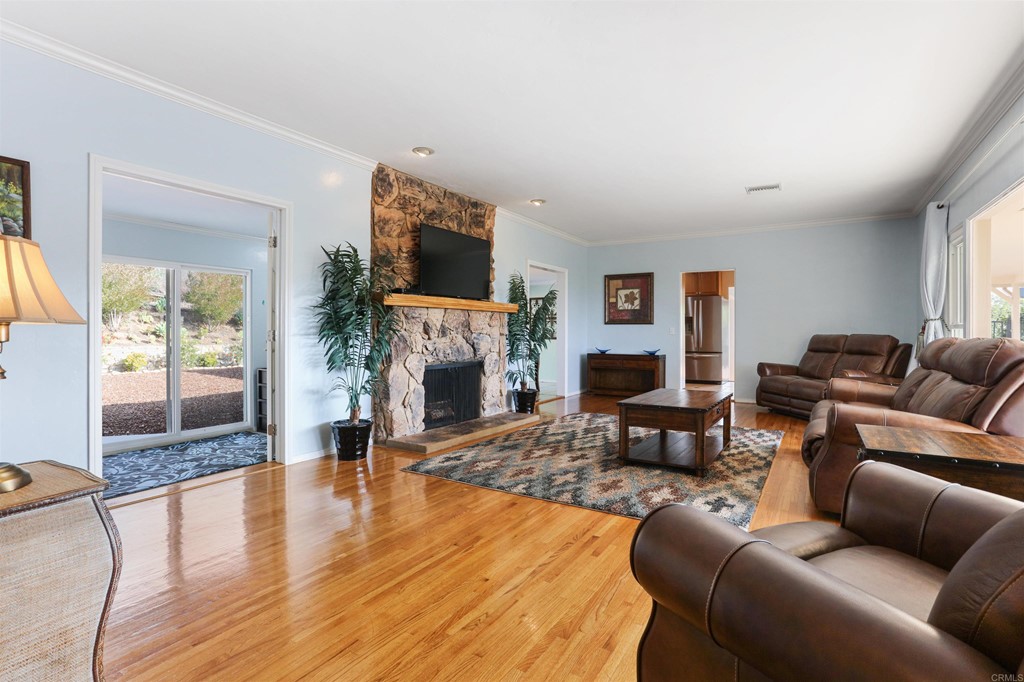 1188 Crystal Lane El Cajon, CA 92020 - Photo 6 of 26 a living room with furniture a fireplace and a flat screen tv