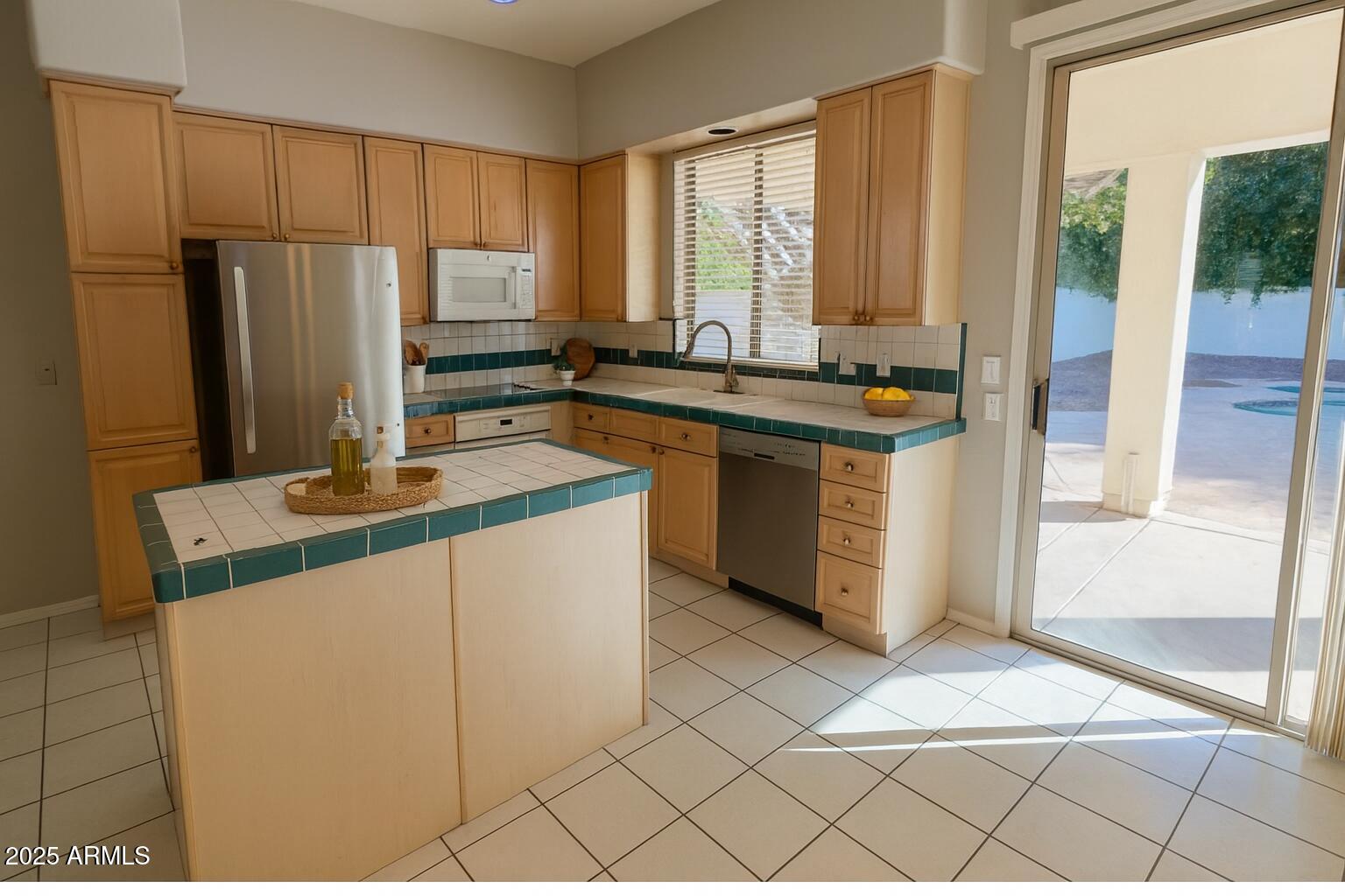 231 East Krista Way Tempe, AZ 85284 - Photo 5 of 20 a kitchen with stainless steel appliances granite countertop a stove a sink and a refrigerator