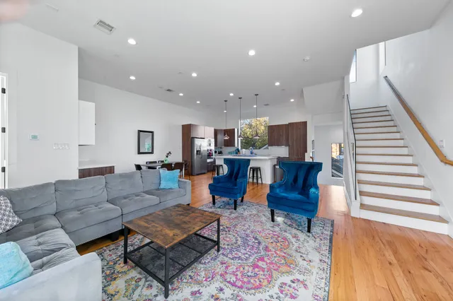 a living room with furniture and wooden floor