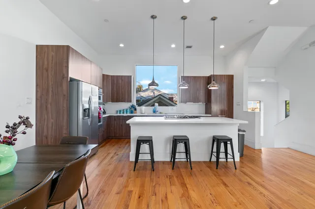 a kitchen with a table chairs refrigerator and microwave