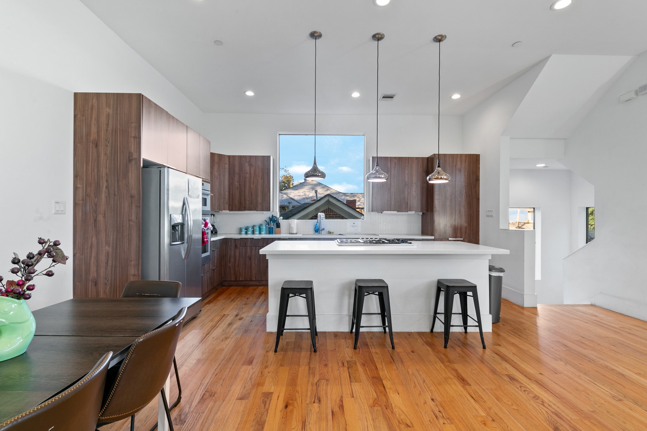 604 Oakley Street Houston, TX 77006 - Photo 13 of 38 A gourmet kitchen anchored by an oversized island and illuminated by designer pendant lighting, creating a sophisticated focal point that elevates the entire second floor living space.