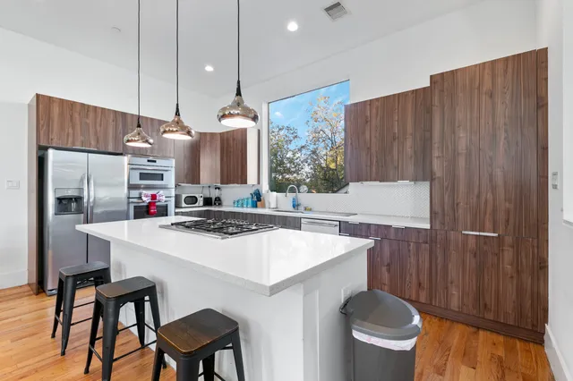 a kitchen with a sink a stove and chairs