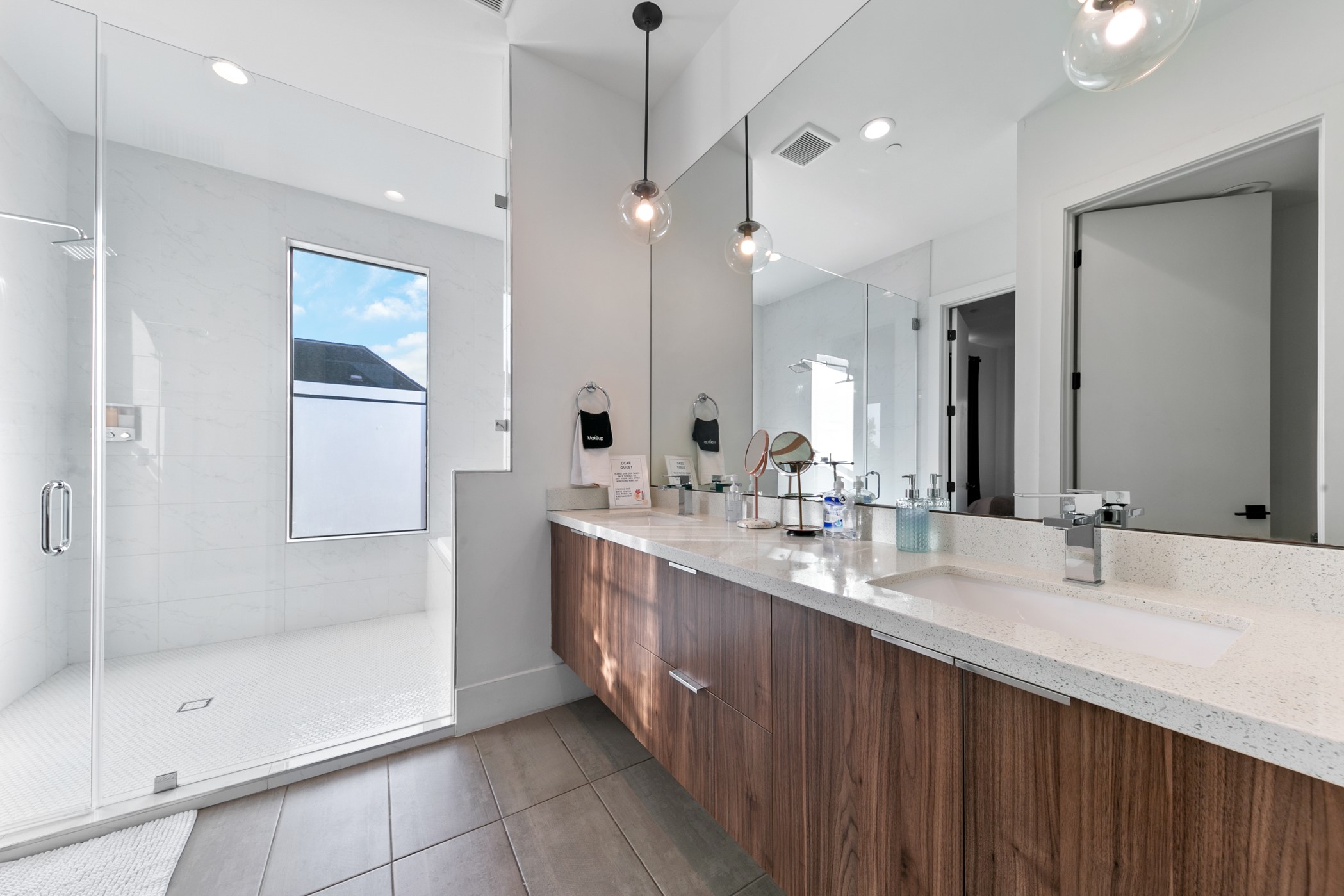 604 Oakley Street Houston, TX 77006 - Photo 23 of 38 Beautiful extended vanity featuring dual sinks and quartz counters for a clean, modern, and highly functional design.