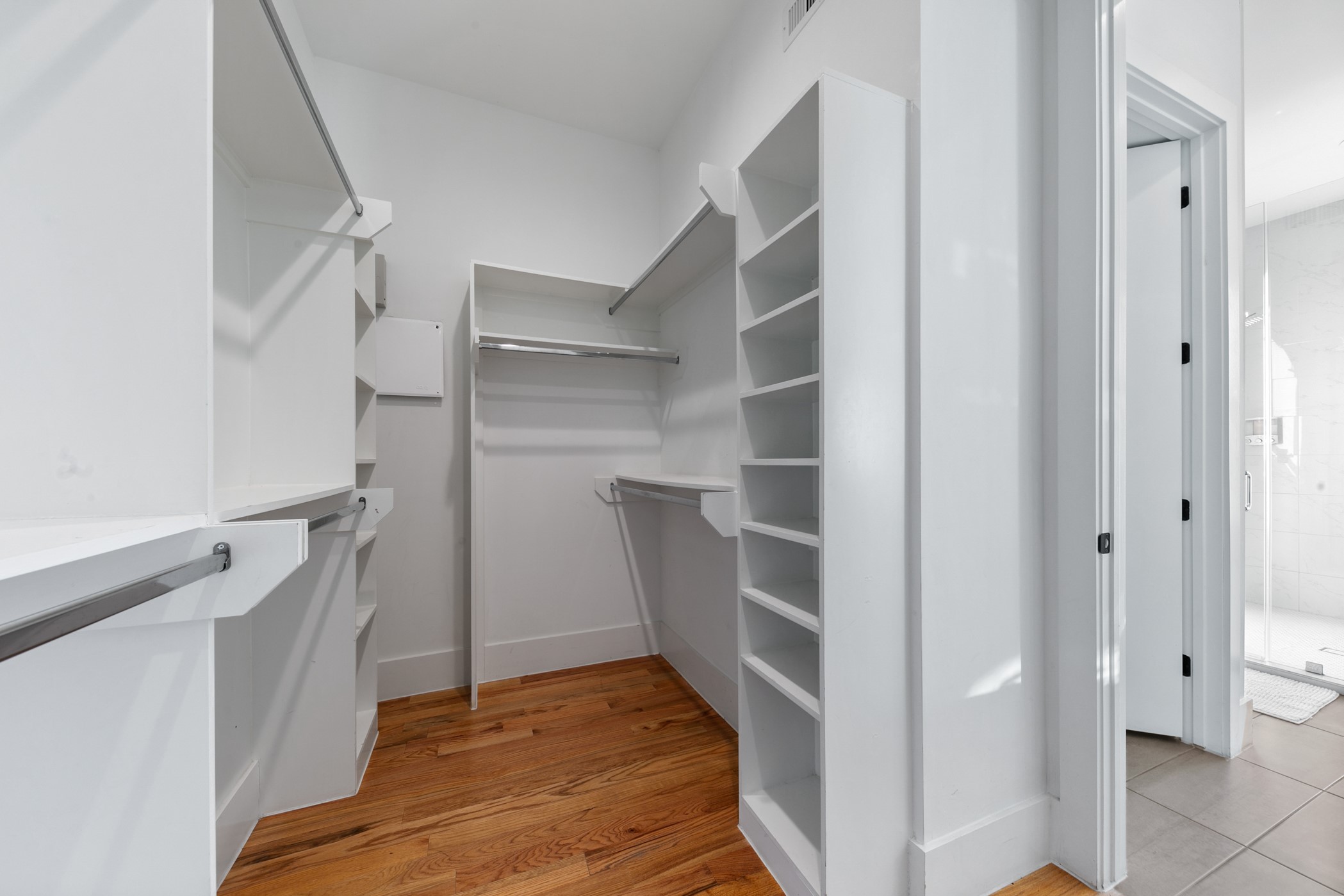 604 Oakley Street Houston, TX 77006 - Photo 24 of 38 Spacious walk in closet featuring custom built ins and ample shelving that provide exceptional storage, easy organization, and a polished, boutique like feel.