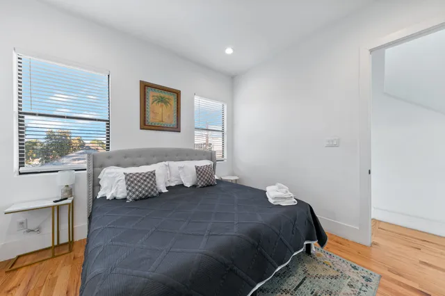 a bedroom with a bed and a window