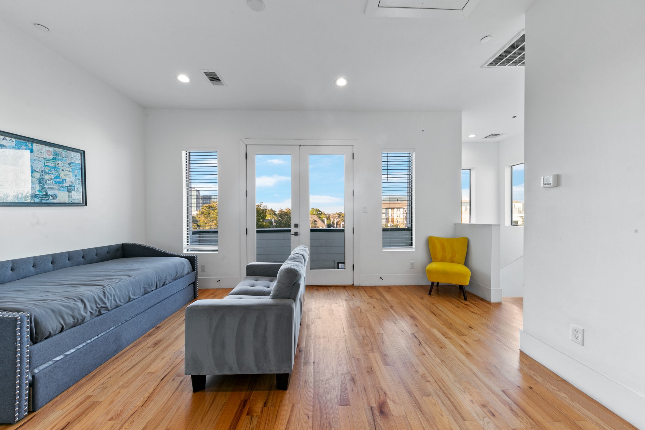 604 Oakley Street Houston, TX 77006 - Photo 29 of 38 Expansive fourth floor game room highlighted by double doors that open to a secondary balcony, enhancing the home’s indoor outdoor flow.