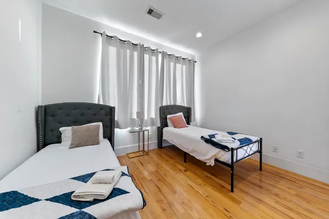 a bedroom with furniture and a rug