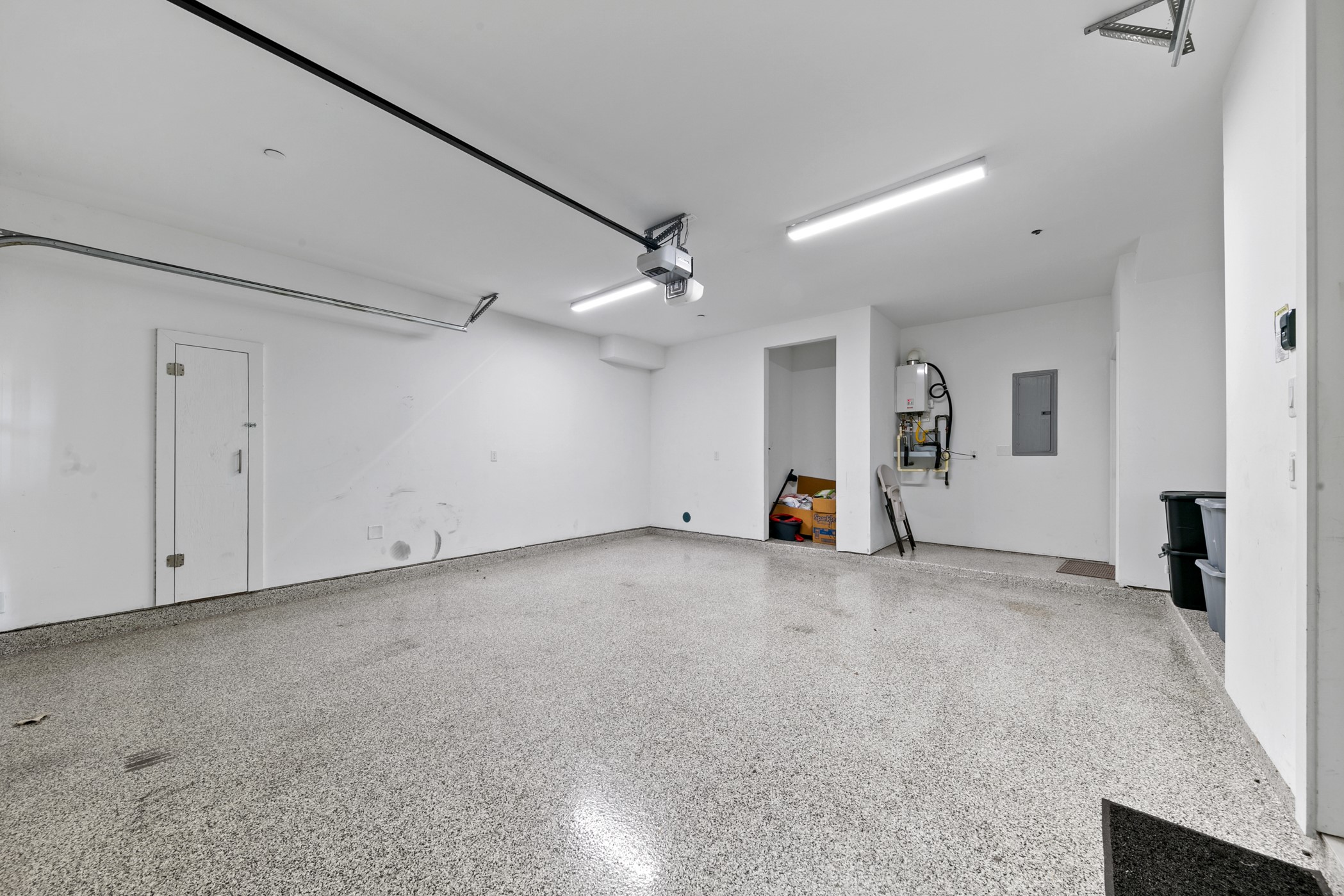 604 Oakley Street Houston, TX 77006 - Photo 6 of 38 Upgraded garage complete with a sleek epoxy floor coating that enhances durability, style, and easy maintenance.