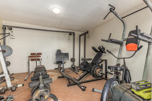 a room with gym equipment and windows