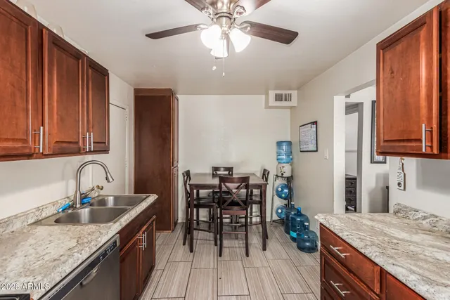 a kitchen with granite countertop a sink appliances and cabinets