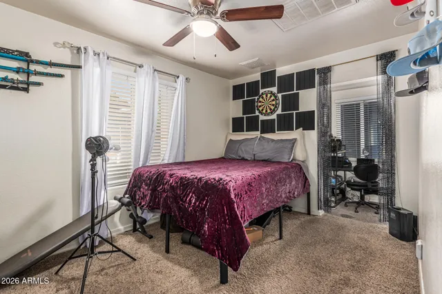 a spacious bedroom with a bed and a window