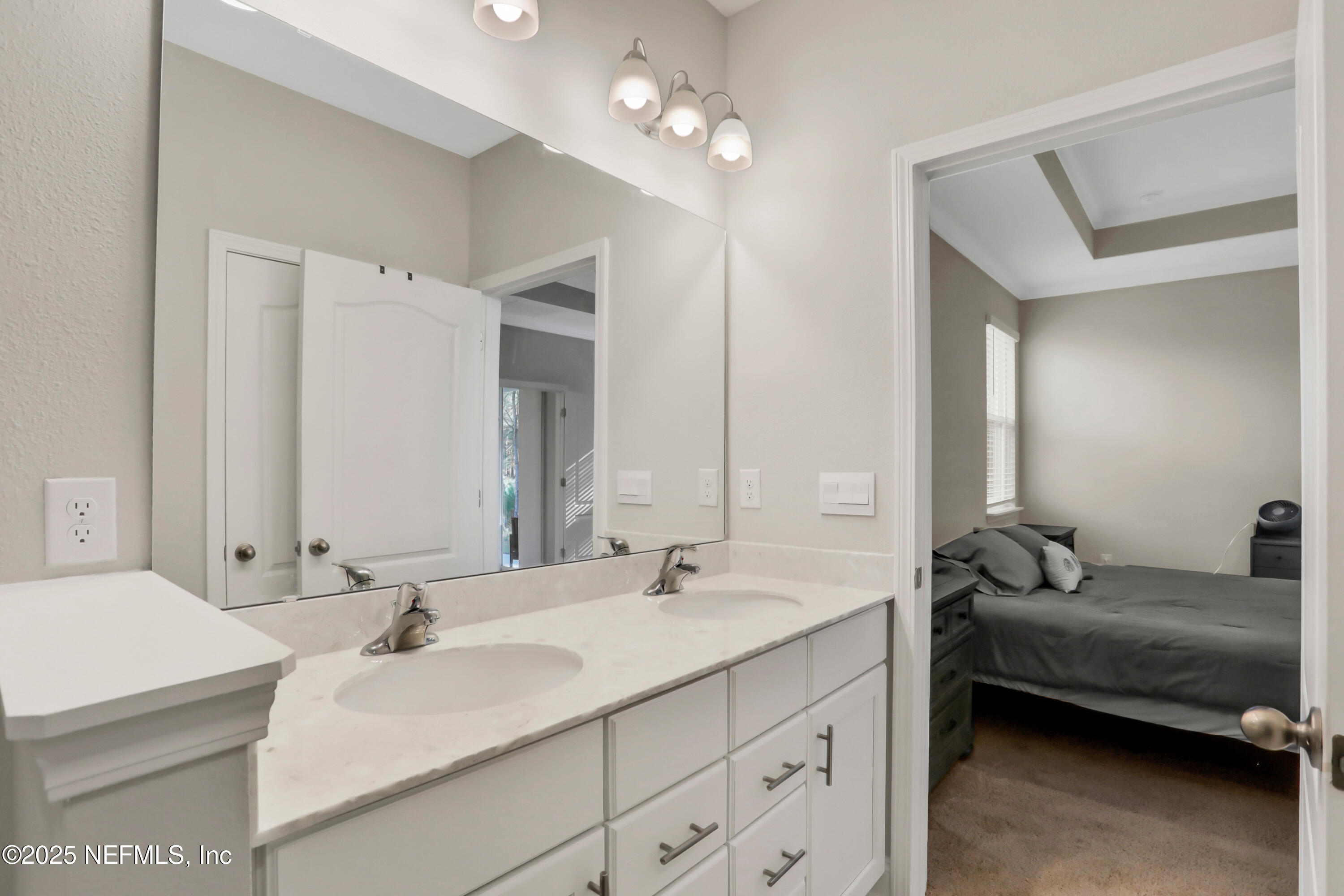 404 Thistleton Way St. Augustine, FL 32092 - Photo 20 of 35 a en suite bathroom with double sink and a mirror