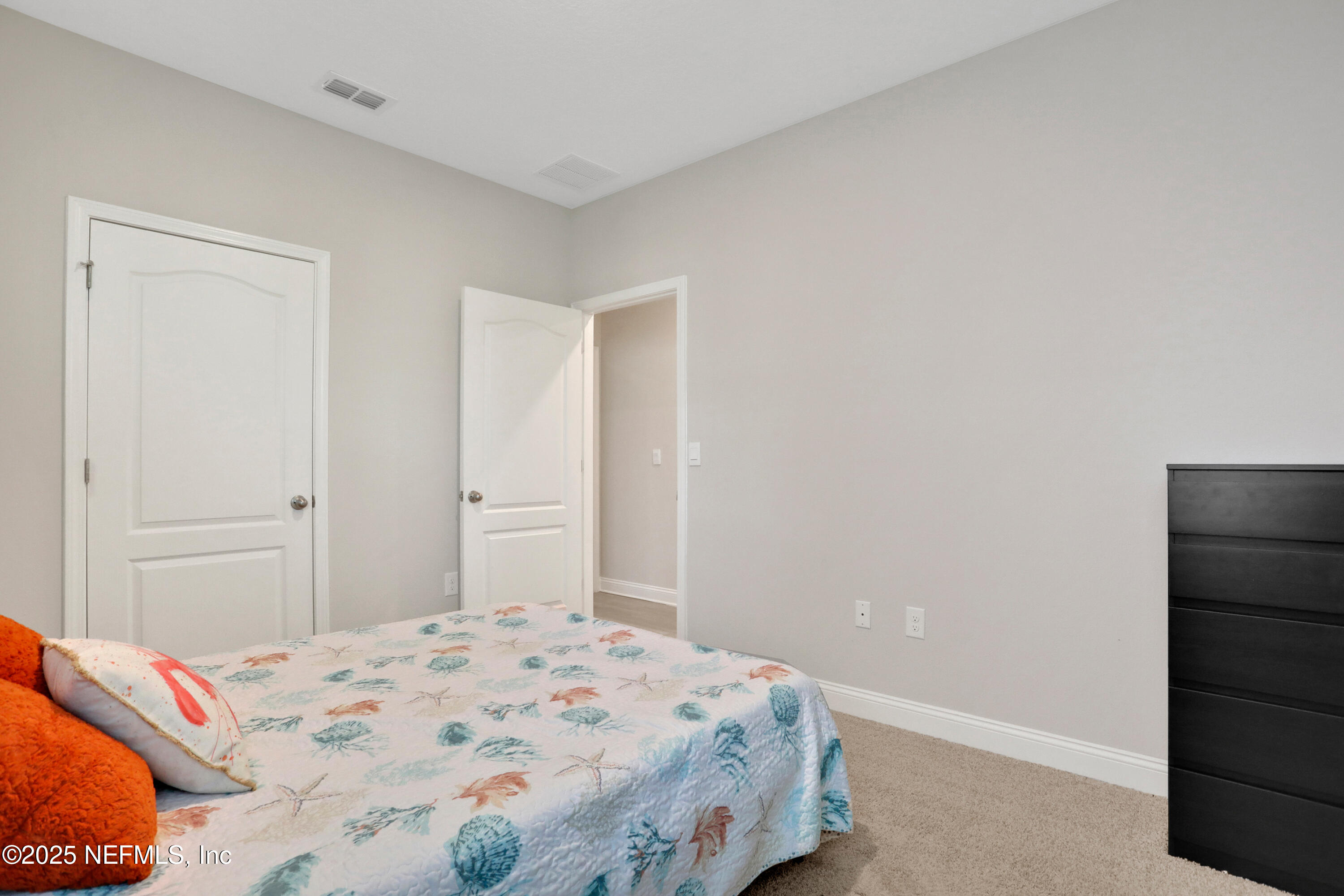 404 Thistleton Way St. Augustine, FL 32092 - Photo 25 of 35 a bedroom with a bed and a cabinets