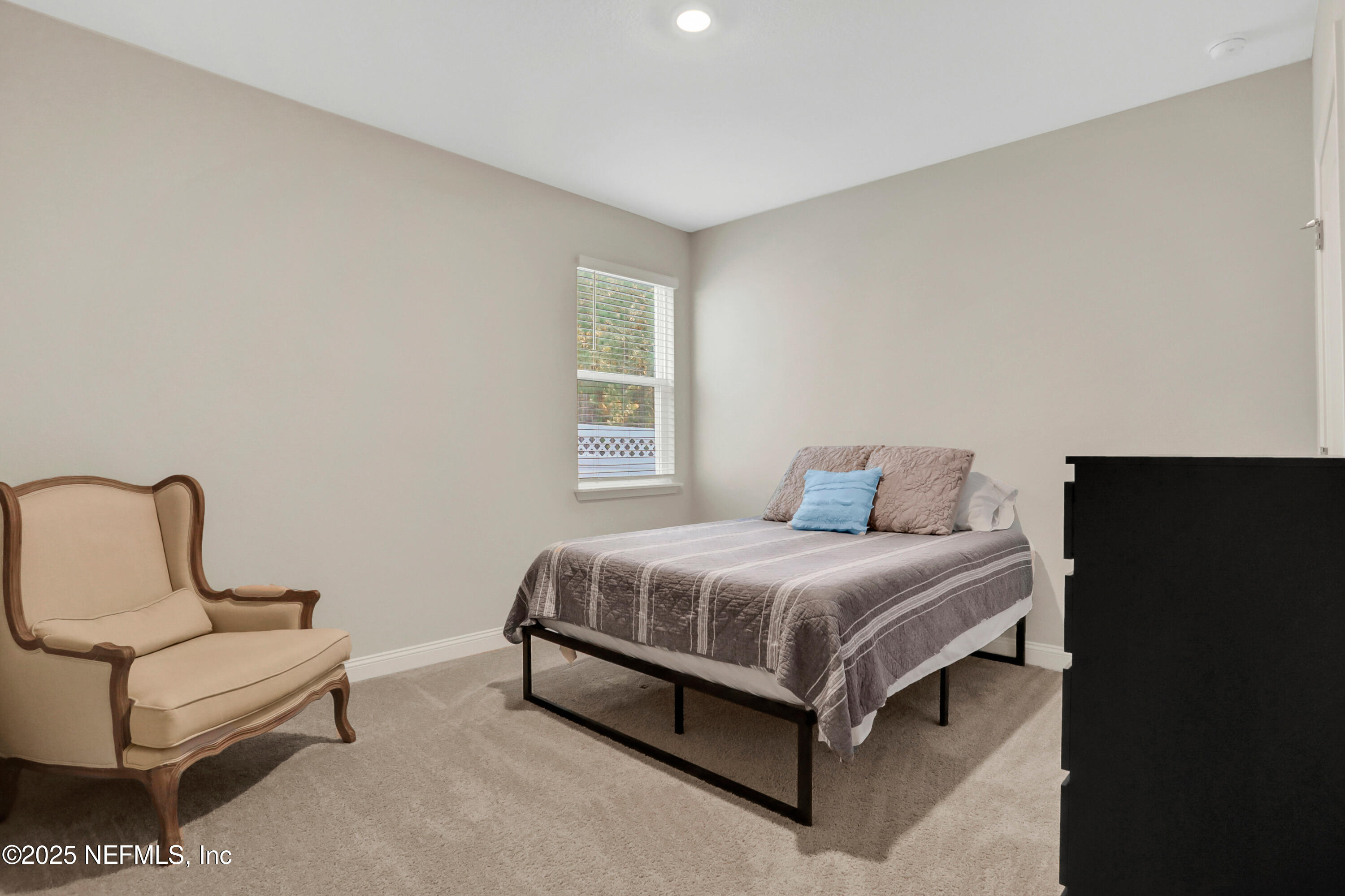 404 Thistleton Way St. Augustine, FL 32092 - Photo 26 of 35 a bedroom with a bed chair and window