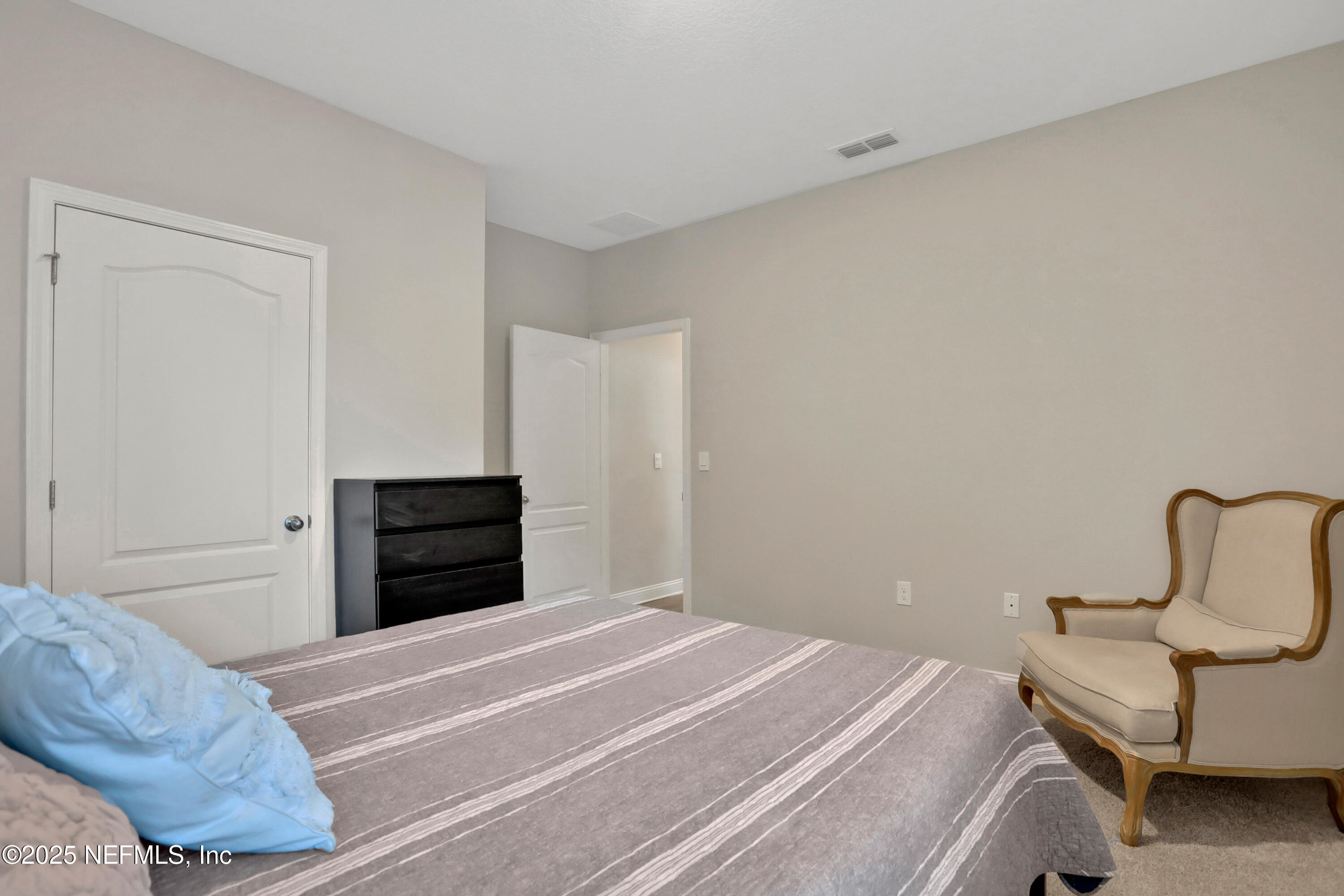 404 Thistleton Way St. Augustine, FL 32092 - Photo 27 of 35 a bedroom with a bed and cabinets