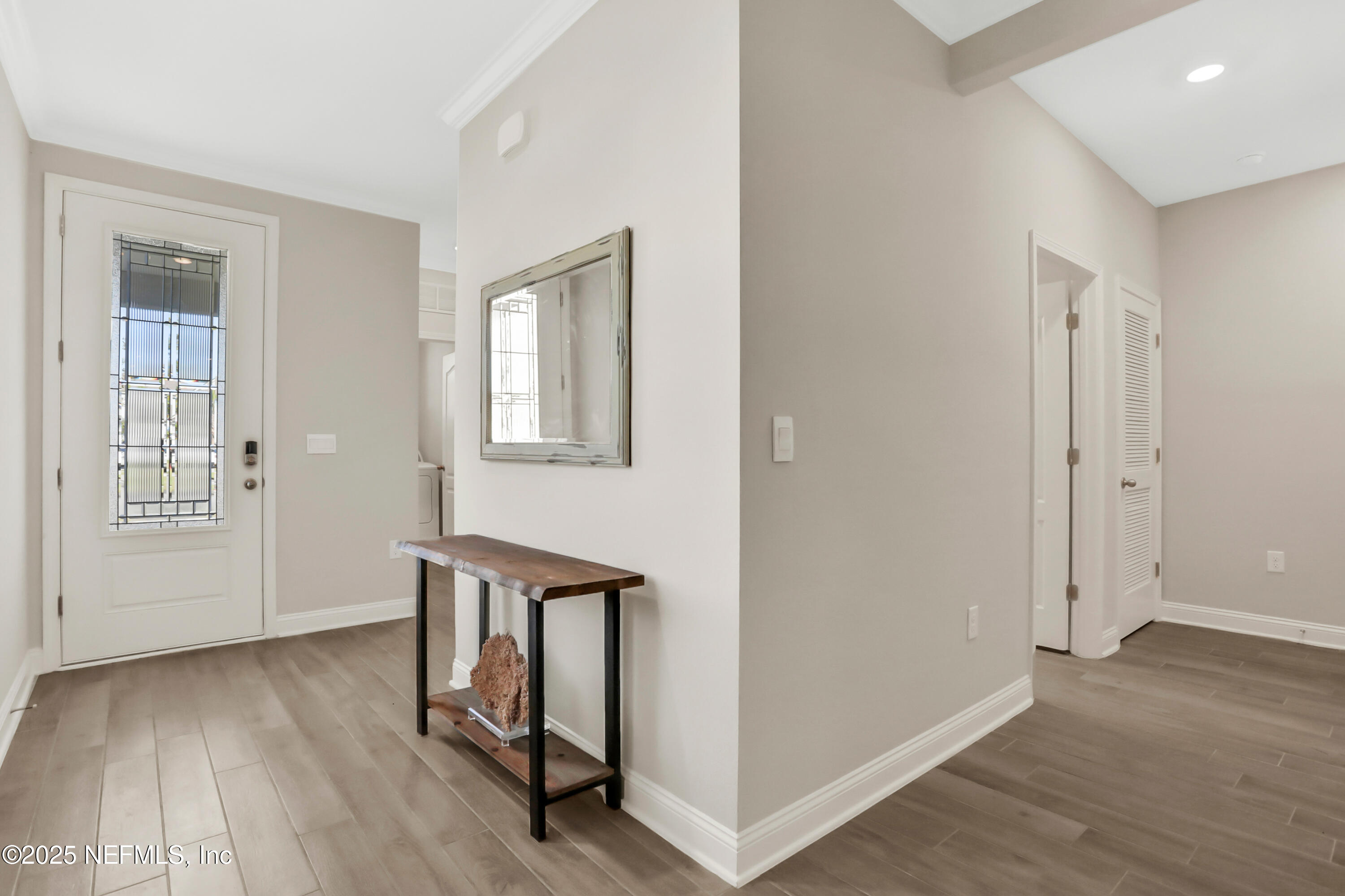 404 Thistleton Way St. Augustine, FL 32092 - Photo 4 of 35 an empty room with wooden floor and windows