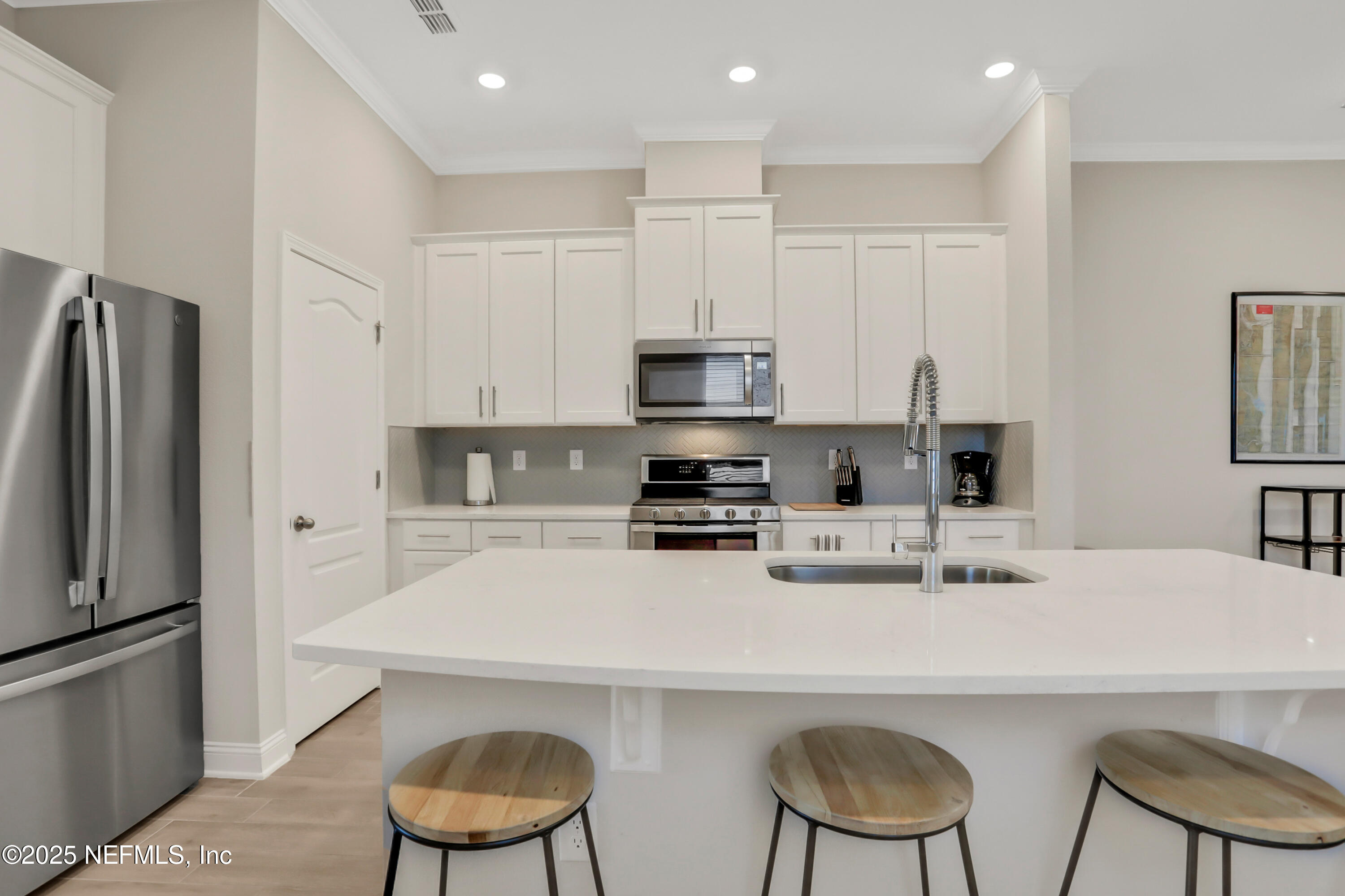 404 Thistleton Way St. Augustine, FL 32092 - Photo 6 of 35 a kitchen with stainless steel appliances a stove a sink and a refrigerator