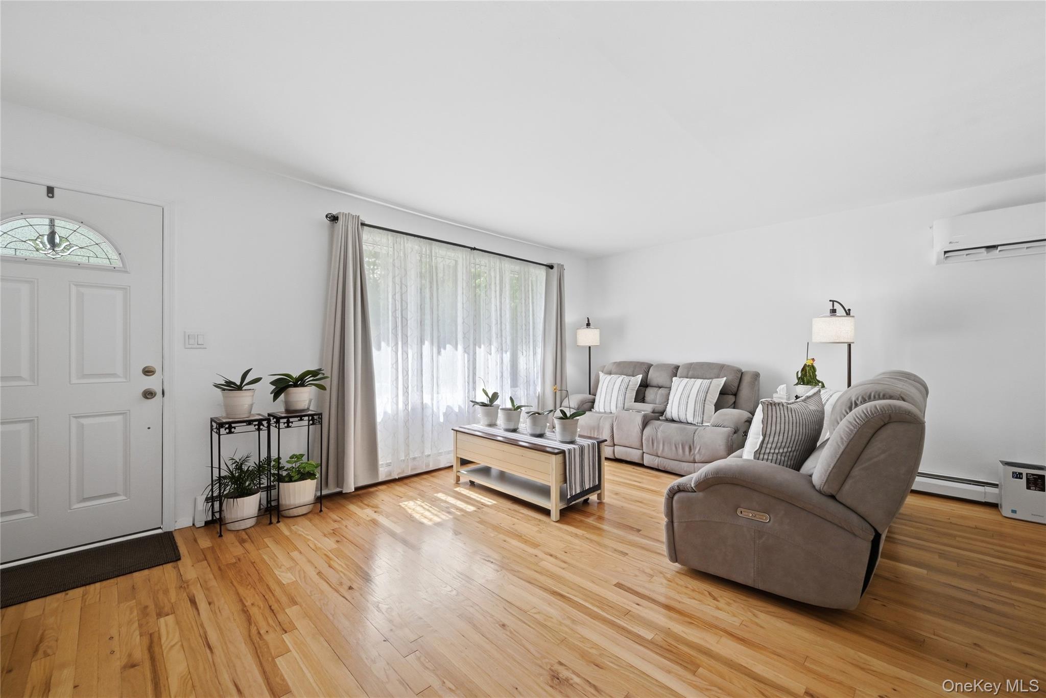 35 Randall Road Shoreham, NY 11786 - Photo 4 of 32 a living room with furniture and a wooden floor