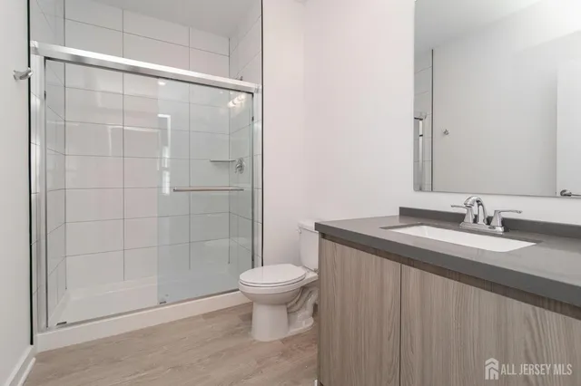 a living room with furniture a flat screen tv and a potted plant